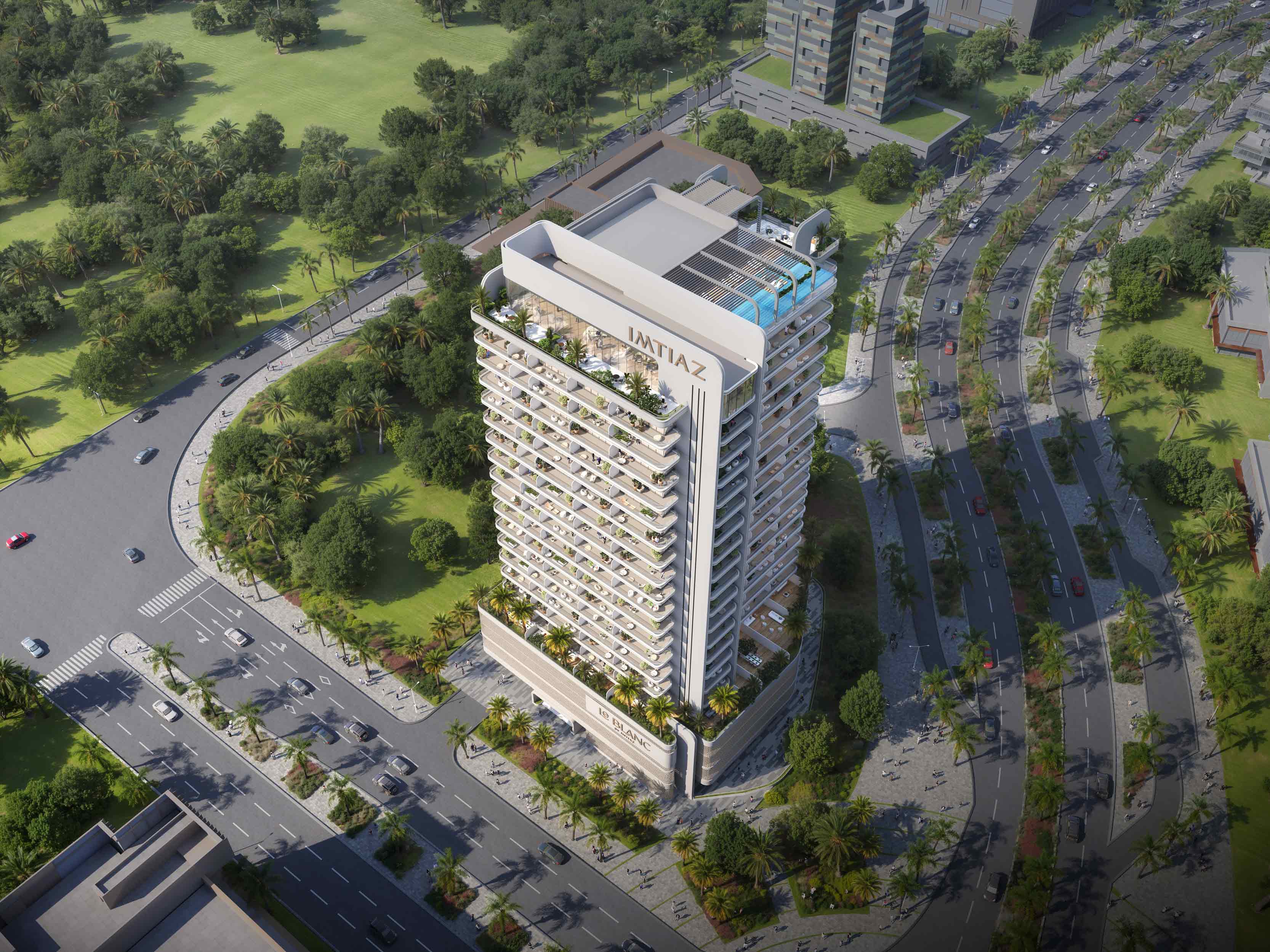 Le Blanc Aerial view of a modern apartment building surrounded by green trees, with roads and cars in the vicinity.
